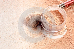 Close-up of crushed mineral shimmer powder golden color with makeup brush