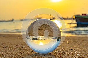close up crystal glass ball put on the beach
