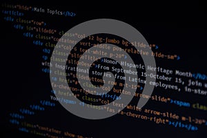 Close up css HTML code on monitor screen with black background