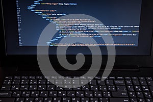 Close up css HTML code on monitor screen with black background