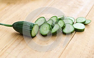 Close up cucumber slice on wood table background.