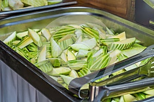 Close Up Of Cucumber Slices Inside A Foodservice Hotel Pan photo