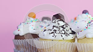 Close up of cup cakes with white cream rotating on the plate served for party