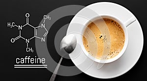 Close up a cup of fresh coffee on a black background. Blackboard with the chemical formula of caffeine. Top view with copy space
