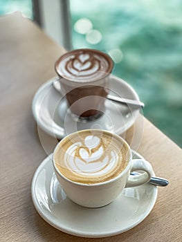Close up Cup of fresh coffee with latte art on wooden table