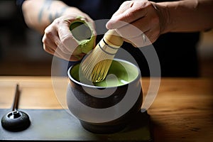 Close up cup of green tea matcha latte in white cup with powder, latte art, hot green tea, milk, soy milk, traditional beverage