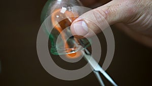 Close up for cupping therapist hand heating up a cupping glass with a flame, isolated on black background. Acupuncturist