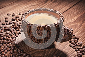 Close-up Cups. Coffee cup with coffee made from coffee beans wooden table. Natural coffee beans arabica.