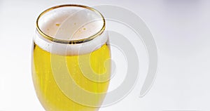 Close up of a cups of Stella Artois full of beer on a white background