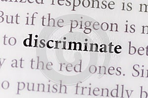 close-up of the term Discriminate on paper background photo