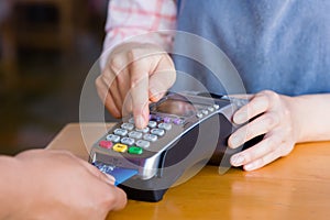 close up customer hand holding and paying for order by credit card in cafe and restaurant.credit card payment service.custumer or