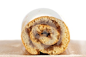 Close-up cut of apple roll sprinkled with powdered sugar.