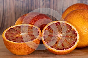 Cut blood oranges isolated on a wooden background