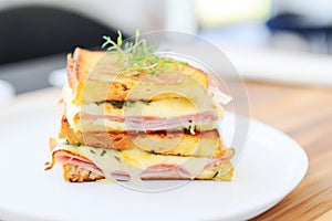 close-up of cut croque monsieur, layers of ham and cheese shown