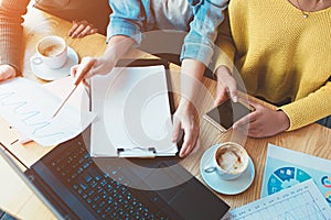 Close up and cut view of three girls sitting together and studying the diagram of money income. They want to analyze how