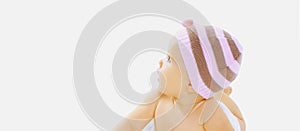 Close up cute baby wearing a hat lying and looking up on a white background