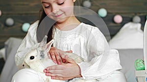 Close up of cute girl stroking the rabbit