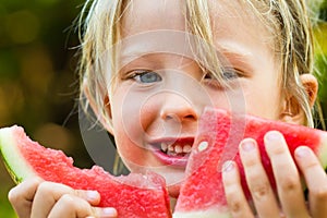 Close-up of cute happy child eating watermelon