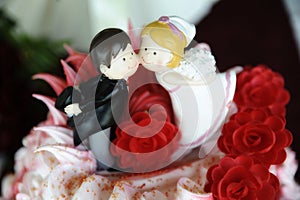 Close up of cute and playful wedding cake topper photo