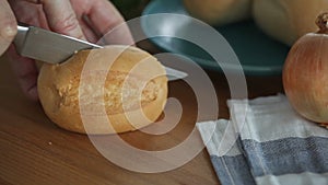 A close-up of Cutting bread on the wooden board