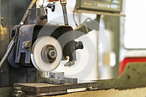 Close up cutting or grinding wheel during rotating or working with product on high accuracy and automatic surface horizontal