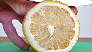 Close Up Of Cutting Lemon Into Slices On A Cutting Board