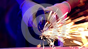 Close up cutting metal, bright sparks from angle grinder machine, craftwork