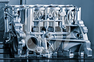 Close-up of the cylinder block in the light blue. Automotive part, machine part