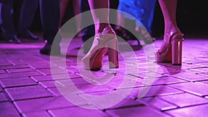 Close-up of dancing feet on the dance floor at a holiday or party.