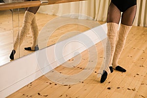 Close-up of dancing legs of ballerina wearing pointe on a dance hall copy space. Ballet dancer and practice concept