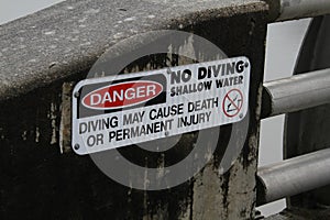 A close up of a danger no diving sign