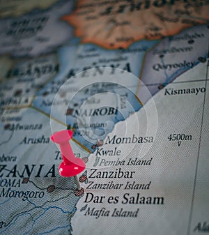 Close up of Dar es Salaam pin pointed on the world map with a pink pushpin