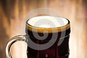 Close-up dark beer with foam in glass