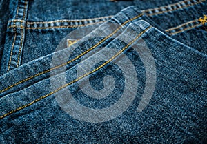 Close up of dark blue old jeans texture background. Blue Jeans texture-gray background