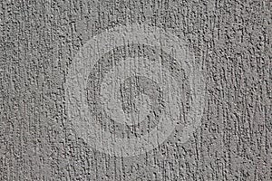 Close up of a dark grey dragged plaster wall. photo