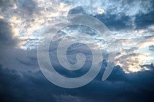 CLOSE UP: Dark grey stormy clouds gather above Lake Maggiore on a calm summer evening. Dramatic shot of clouds covering up the