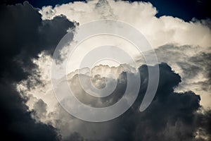 CLOSE UP: Dark grey stormy clouds gather above Lake Maggiore on a calm summer evening. Dramatic shot of clouds covering up the