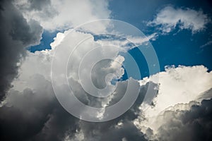 CLOSE UP: Dark grey stormy clouds gather above Lake Maggiore on a calm summer evening. Dramatic shot of clouds covering up the