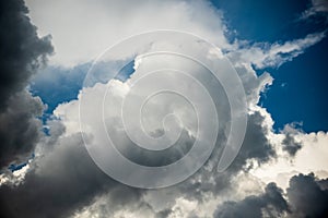 CLOSE UP: Dark grey stormy clouds gather above Lake Maggiore on a calm summer evening. Dramatic shot of clouds covering up the