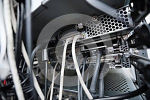 Close-up of data cable plug connected to servers in computer lab