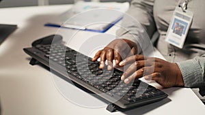 Close up of data center admin coding on PC, typing on computer keyboard