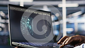 Close up of data center admin using machine learning algorithms on laptop