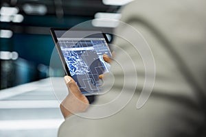 Close up of data center developer using AI software on tablet