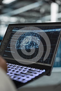 Close up of data center developer using artificial intelligence on laptop