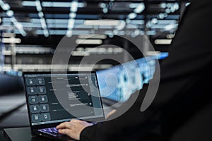 Close up of data center engineer using AI assistant on laptop