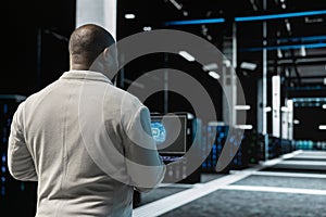 Close up of data center engineer using AI on laptop to optimize performance