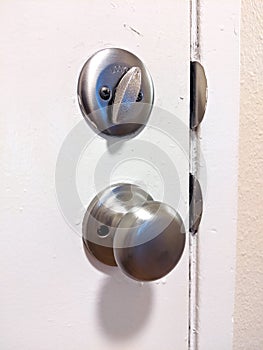 Close up of a deadbolt on the front door of a house