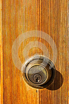 Close-Up of Deadbolt Lock on Brown Door