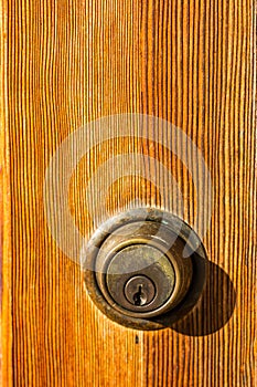 Close-Up of Deadbolt Lock on Brown Door photo