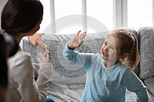 Close up deaf little girl communicating with mother